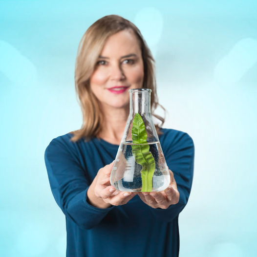 Graydon Skincare founder, Graydon Moffat, holding a beaker with a plant leaf inside.