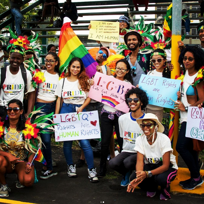 LGBTQI+ people together holding rainbow flags