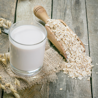 Oat milk alternative on a rustic wood surface