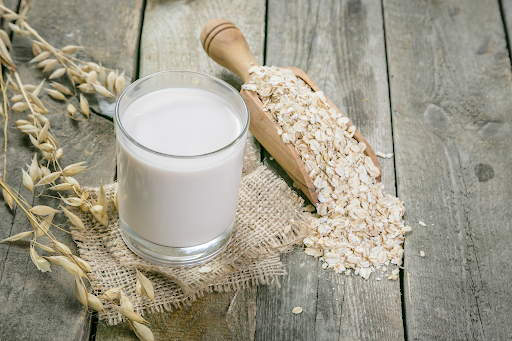 Oat milk alternative on a rustic wood surface