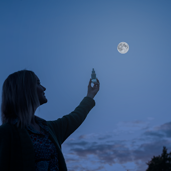 A shadow of a woman holding a bottle of Fullmoon Serum with a full moon in the night sky